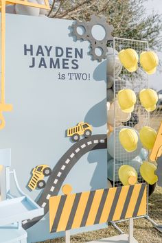 there is a sign that says hayden james is two with construction vehicles on it