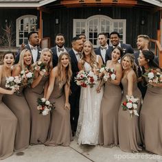 a group of people standing next to each other in front of a building holding bouquets