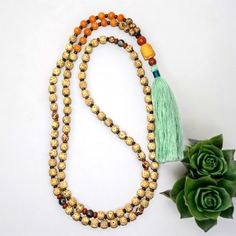 - Handcrafted Bodhi Seed | Tibetan Agate With Bronzite 8mm Gemstone Mala Necklace The Mala Is Made With 108 (8mm) Gemstone Beads. The Length Is Approximately 51.5" And Includes The Tassel. The Beads Are Bodhi Seed. The Spacer Beads In-Between The Bodhi Seeds Bronzite And The Sectional Spacer Beads Are Red Jasper & Teal Blue Tibetan Agate Gemstone Beads. The Guru Bead Is A Suzhou (Pronounced, "Soochow") Jade Carved Buddha Head With An 10mm Red Jasper Bead On The Top And An 8mm Red Jasper Gemstone Gold Healing Mala With 108 Beads, Gold Mala With 108 Beads For Healing, Orange Jewelry With 108 Beads For Meditation, Gold Mala With 8mm Beads For Meditation, Gold Mala With Round Beads For Healing, Gold Spiritual Mala For Healing, Bohemian Orange Jewelry For Meditation, Bohemian Agate Mala With Gemstone Beads, Gold 108 Beads Mala For Meditation