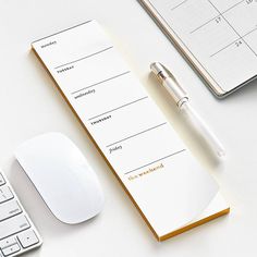 a desk with a keyboard, mouse and calendar