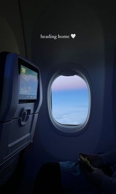 an airplane window with the view of the sky and clouds through it's screen