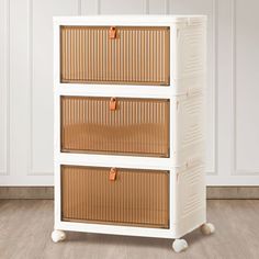 a white cabinet with three wicker drawers