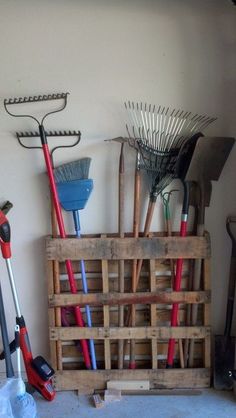 some tools are sitting on top of a wooden crate in a room with white walls