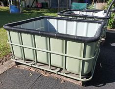 a large green container sitting on top of a sidewalk