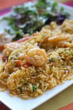 rice with shrimp and vegetables on a white plate