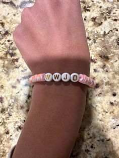 a what would Jesus do clay bead bracelet with pink white and orange colors Wwjd Clay Bead Bracelet, Clay Bead Bracelets, What Would Jesus Do, Clay Bead Bracelet, Clay Bead, White And Orange, Slumber Party, Bead Bracelets, Slumber Parties