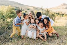 a group of people that are standing in the grass with some kids and an adult