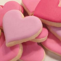 some heart shaped cookies are on a table