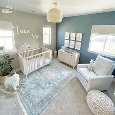 a baby's room with blue walls and white furniture