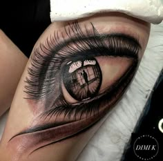 a close up view of an eye tattoo on the leg