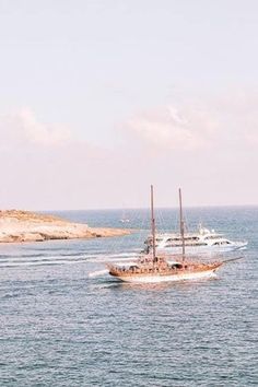 two boats are sailing in the open water