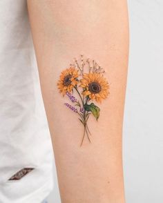 a sunflower tattoo on the right arm