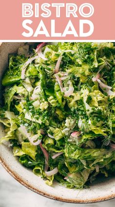 a white bowl filled with lettuce and onions