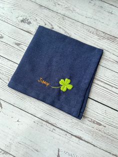 a blue napkin with a green leaf on it