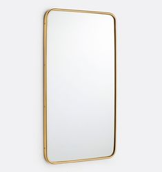 a gold framed mirror hanging on the wall