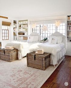 a bedroom with two beds and baskets on the floor