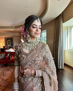 a woman in a bridal outfit is posing for the camera