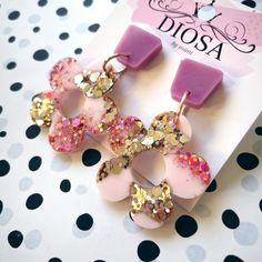 the pink and gold earrings are decorated with sequins, glittery circles and hearts