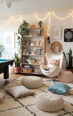 a living room filled with lots of furniture and decor on top of a white rug