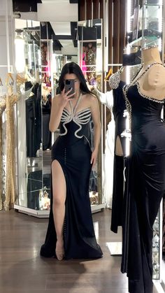 a woman taking a selfie in front of a dress