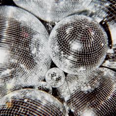 an image of some disco balls that are in the middle of each other's face