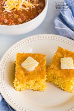 two pieces of cornbread on a white plate