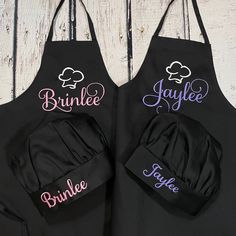 two personalized aprons are shown on a wooden table