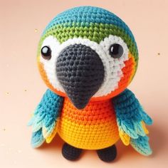 a small crocheted parrot with big eyes