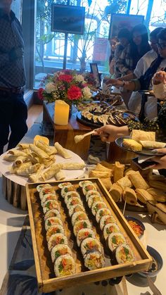 a buffet table with many different types of sushi and other food items on it