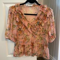 Nwot Zara Sheer Ruffled Floral Top Size Xs. No Flaws. Pretty Details. Loose Fit. The Color Is A Pink Maeve 21” Length And 18” Chest Zara Floral Print Blouse For Spring, Zara Short Sleeve Blouse For Spring, Zara Feminine Short Sleeve Tops, Feminine Zara Tops With Floral Print, Zara Short Sleeve Blouse With Ruffles, Zara Feminine Floral Print Tops, Feminine Floral Print Zara Tops, Zara Feminine V-neck Top, Pink Floral Print V-neck Blouse