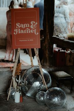 Orange and white wedding welcome sign on a wooden easel with disco ball decor and dried flowers for rustic glam wedding Wedding Welcome Sign Disco Ball, Boho Disco Wedding Decor, Disco Wedding Welcome Sign, Disco Ball Welcome Sign, Disco Rehearsal Dinner, Disco Ball Reception Decor, Disco Welcome Sign, Rustic Disco Wedding, Disco Theme Wedding Decor