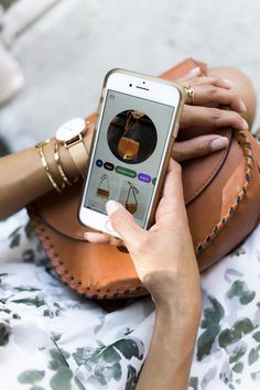 a woman holding a cell phone in her hand