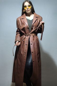 Elegant Brown Leather Jacket For Winter, Brown Long Fur Coat For Work, Elegant Long Brown Leather Jacket, Winter Faux Leather Belted Jacket, Elegant Brown Leather Long Coat, Brown Leather Long Coat For Fall, Brown Long Fur Coat For Fall, Classic Long Brown Outerwear, Brown Leather Fur Coat For Workwear