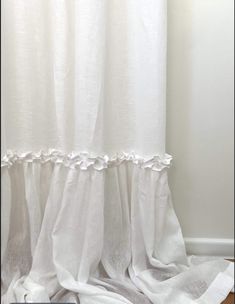 a white shower curtain with ruffled edges