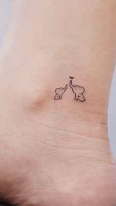 a small tattoo on the ankle of a woman's foot, with an elephant