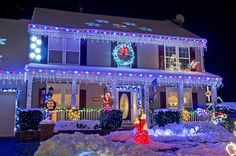 a house covered in christmas lights and wreaths