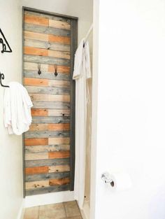 a bathroom with a wooden door and towel rack