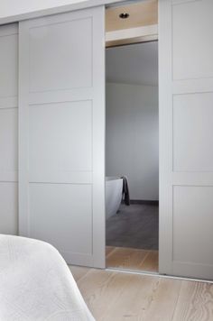 an image of a bedroom with white closet doors