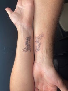 two people are holding hands with tattoos on their arms, one has a horse and the other has a bird