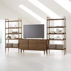 an entertainment center with shelves and a flat screen tv