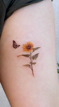 a small sunflower with a butterfly on it's back side ribcage