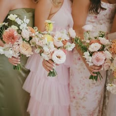 three bridesmaids holding bouquets of flowers in their hands