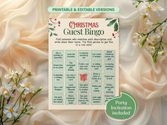 a christmas guest bingo game with white flowers and greenery in the background, surrounded by satin fabric