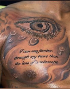 a man's chest with an eye on it and the words, i can see further through my tears than the lens of telescope