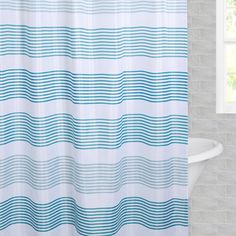 a shower curtain with wavy lines in blue on the outside and white on the inside