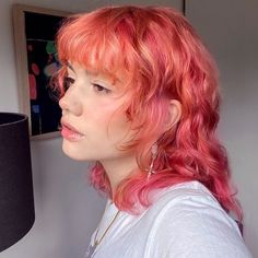 a portrait of a young woman with hot pink hair and mullet hairstyle Shag Mullet Thick Hair, Pink Red And Orange Hair, Light Pink And Ginger Hair, Autumn Vivid Hair Color, Cute Pink Hair Dye Ideas, Mullet Layered Hair, Orange To Pink Hair, Pink And Orange Hair Short, Ginger Hair Pink Highlights