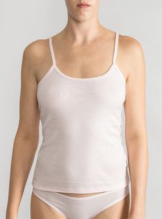 Lightweight layer in breathable organic cotton A wardrobe essential that’s perfect on its own or layered with a sweater. The camisole’s sweetly scooped neckline and slender spaghetti straps flatter décolletage and add understated elegance to the everyday. Made in North Carolina using 100% USA-grown organic cotton— the best and softest around. Wear your Lake Jane bralette under for a cool layered look! Because of the high quality of this organic fabric, you’ll get tons of wear out of your cami wi Daywear Camisole With Built-in Bra And Scoop Neck, Loungewear Camisole With Adjustable Straps And Scoop Neck, Scoop Neck Camisole With Adjustable Straps For Loungewear, Feminine Tank Top With Spaghetti Straps And Built-in Bra, Feminine Tank Top With Built-in Bra, Cotton Tops With Delicate Straps For Loungewear, Spring Cotton Camisole With Wide Straps, Scoop Neck Camisole For Spring Loungewear, Spring Loungewear Camisole With Scoop Neck