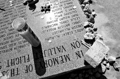 a black and white photo of an inscription on a stone with two drinks in it