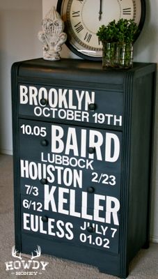 a black cabinet with white lettering and a clock on top