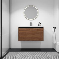 a bathroom with a round mirror above the sink and a wooden cabinet below it,